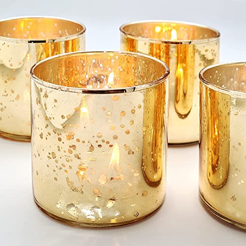 Shiny gold tea lights on a white background.