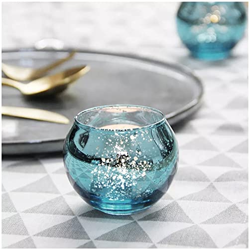 Blue glass tealight holders on a table