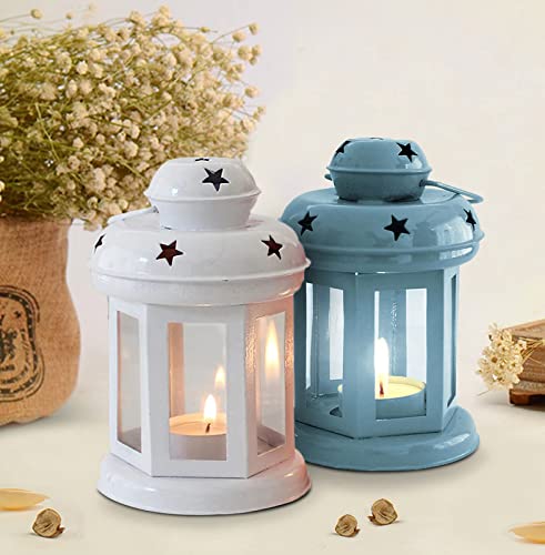 Two white and blue lanterns with candles glowing inside, creating a warm and cozy atmosphere.