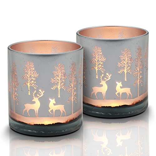 Two glass candles with deer designs, great for adding a festive and cozy vibe to your home.