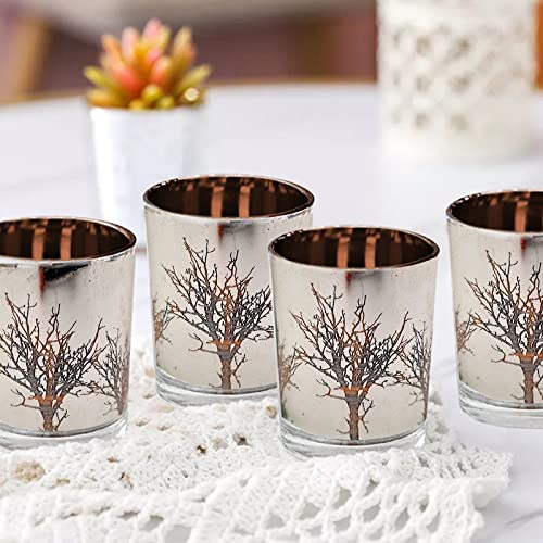 Four glass votive holders embellished with tree designs, adding a rustic charm to your living space.