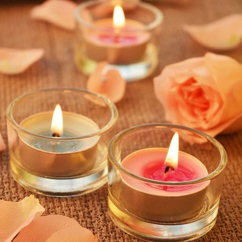 Group of petite candles enclosed in see-through glass containers.