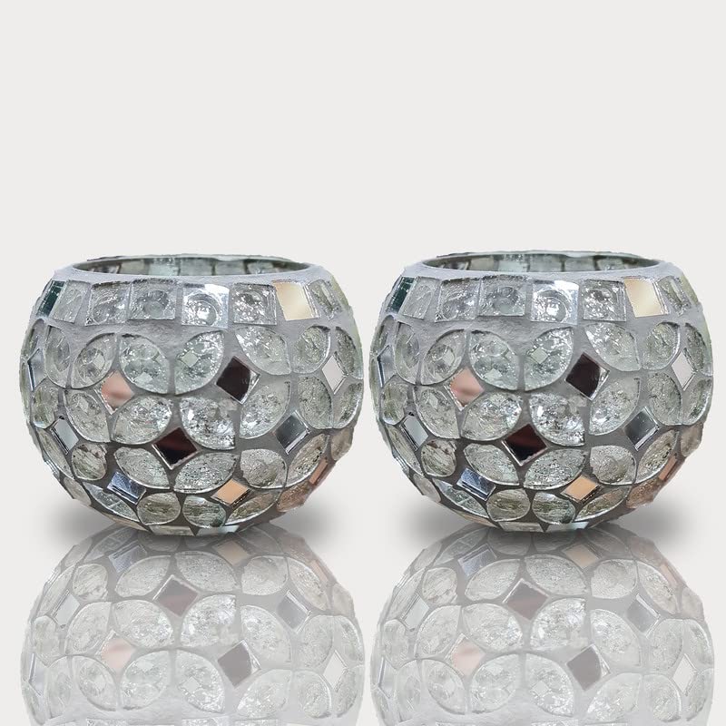 Two silver glass balls with crystals, reflecting light, on a dark background.