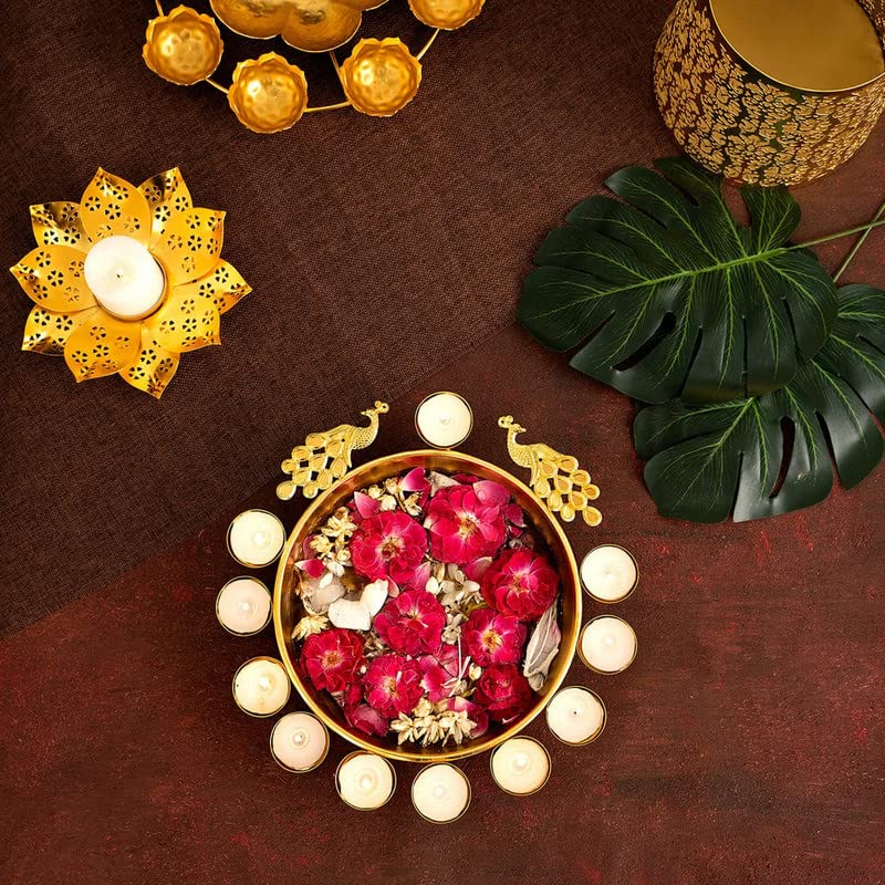 Luxurious gold plate embellished with colorful flowers and lit candles.