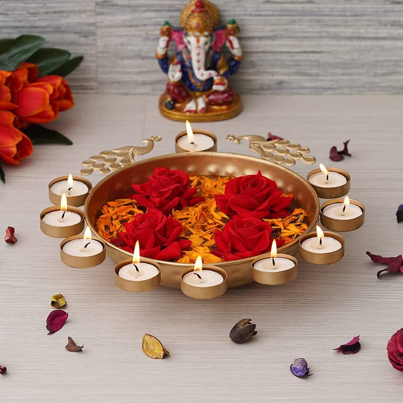 Intricately designed gold plate with lovely flowers and lit candles.