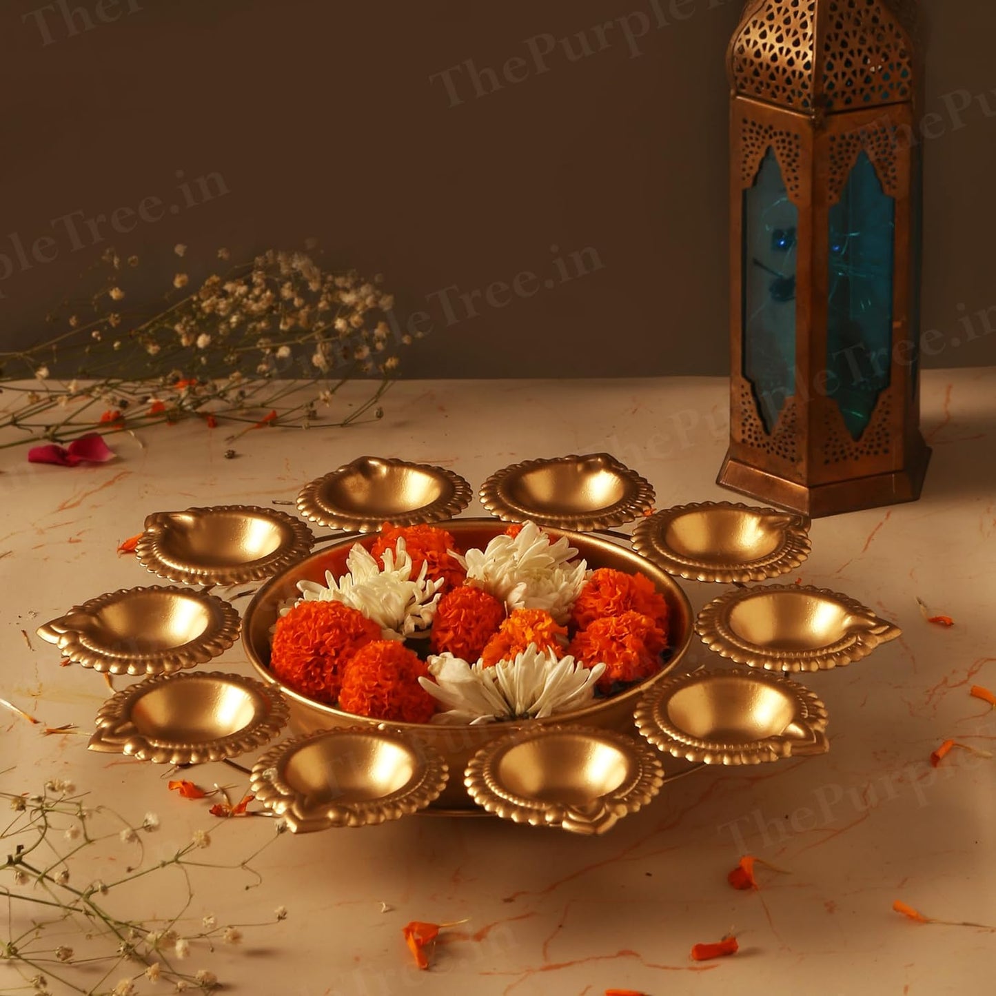  Vibrant flowers and glowing candles placed in a small bowl, offering a lovely and peaceful decorative touch.