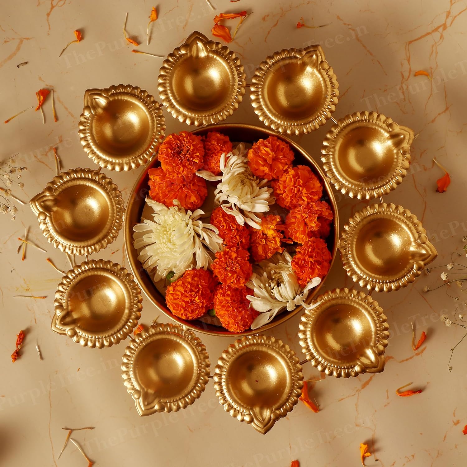 A small bowl filled with colorful flowers and lit candles, creating a serene and inviting atmosphere.