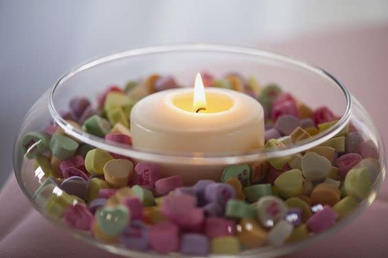 Rocks and stones surrounding a candle in a glass bowl.