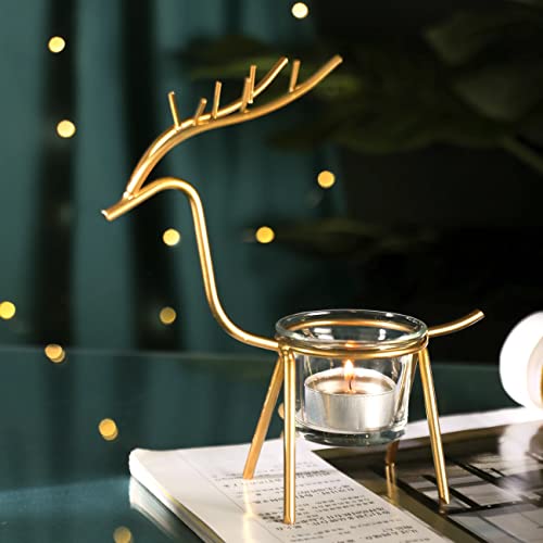 A golden reindeer candle holder sitting on a table.