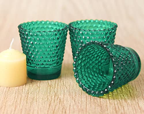 Collection of green glass candle holders for small candles