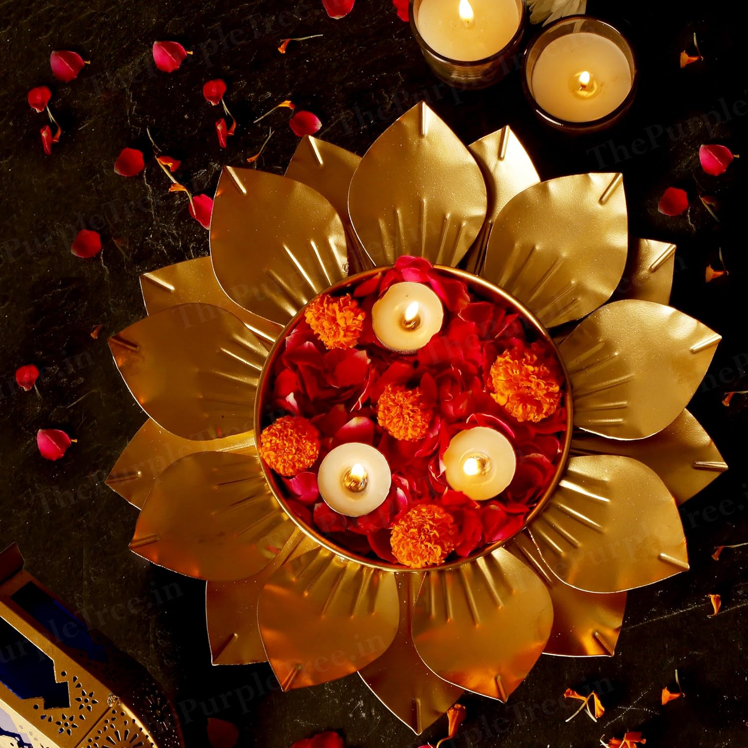 Shiny flower diya with burning candles, representing hope and joy in traditional ceremonies.