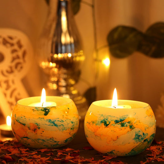 Two candles with yellow and blue designs, perfect for adding a cozy ambiance to any room.