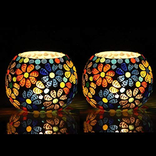 Two colorful glass tealights placed on a table