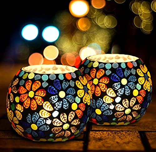 Two vibrant glass tealights on a table