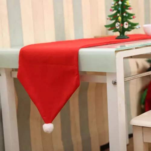 A Christmas-themed red Santa hat on a table.