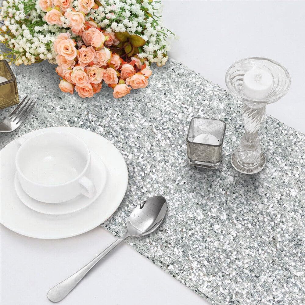 Shiny silver sequin table runner adorned with delicate flowers.