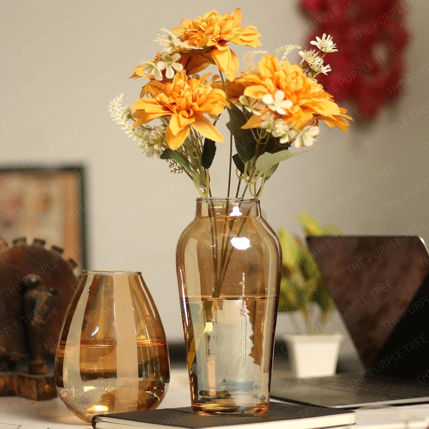 Two vases filled with colorful flowers sit gracefully on a table, adding a touch of beauty and vibrancy to the room.