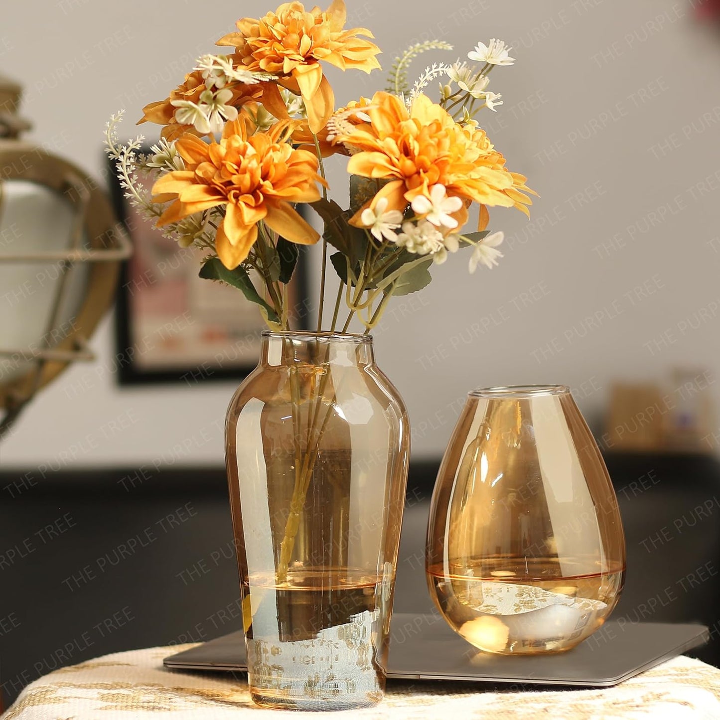 Two vases filled with colorful flowers sitting on a table. A beautiful display of nature's beauty.