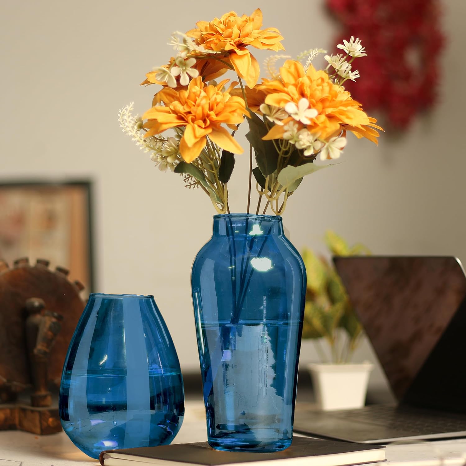 Beautiful blue vase filled with flowers.