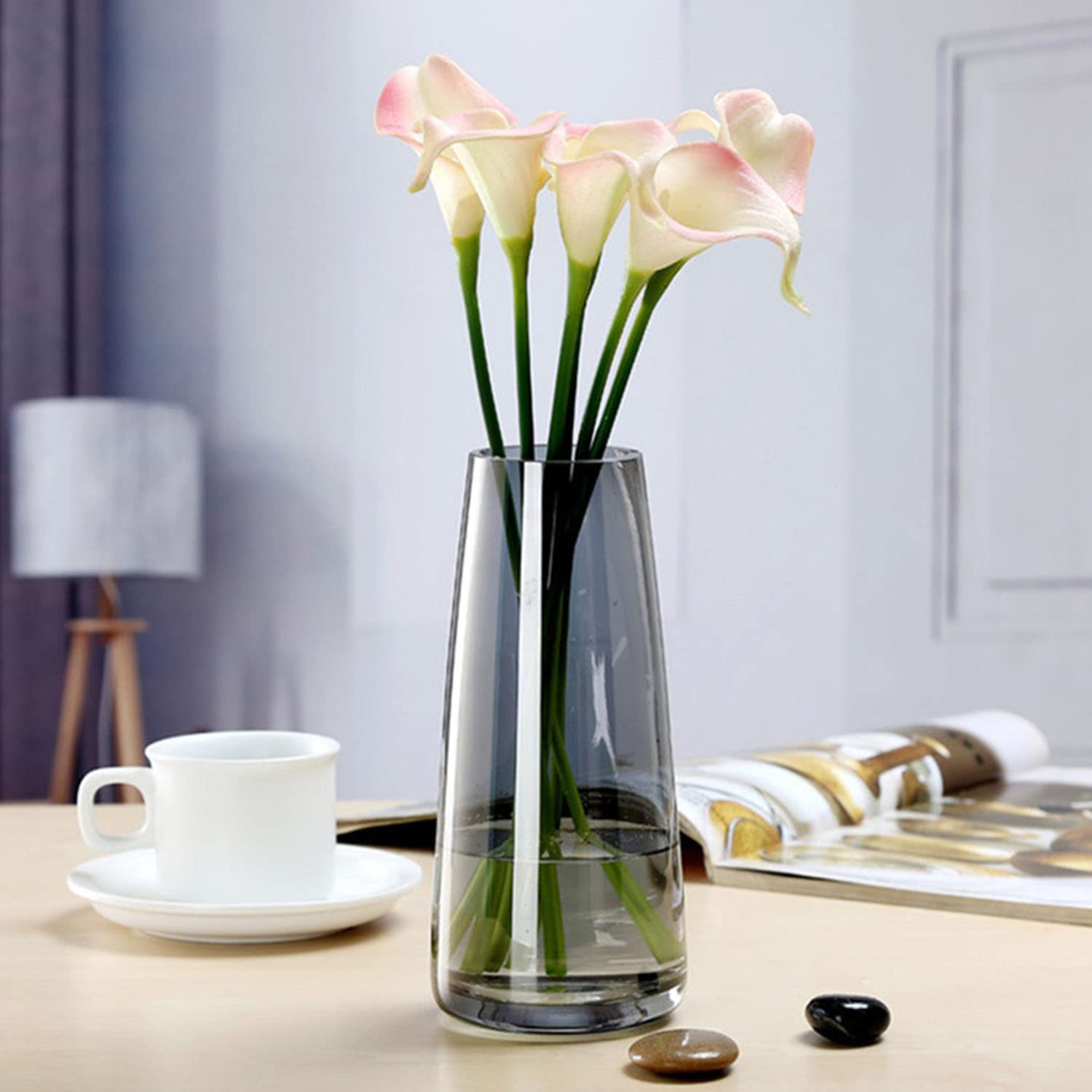 A table adorned with flowers in a vase and a book.