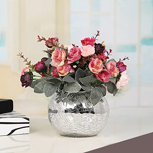  A vase filled with colorful flowers on a wooden table.