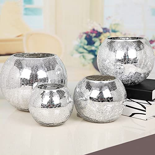 Four silver vases elegantly displayed on a table.