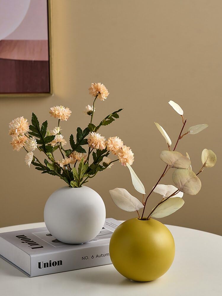 A beautiful vase of flowers and a book resting on a table, creating a lovely and peaceful scene.