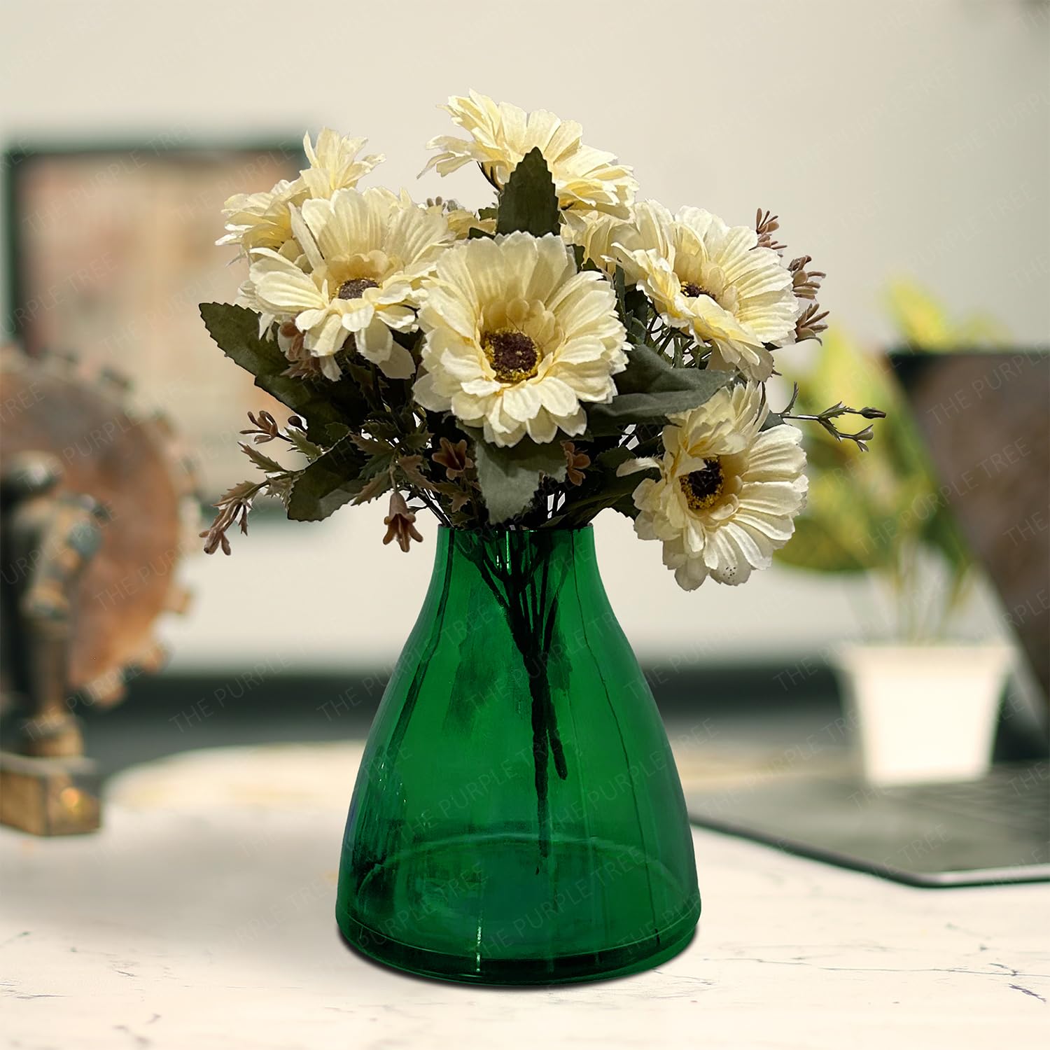 A green vase filled with a variety of colorful flowers, elegantly arranged for a vibrant display.