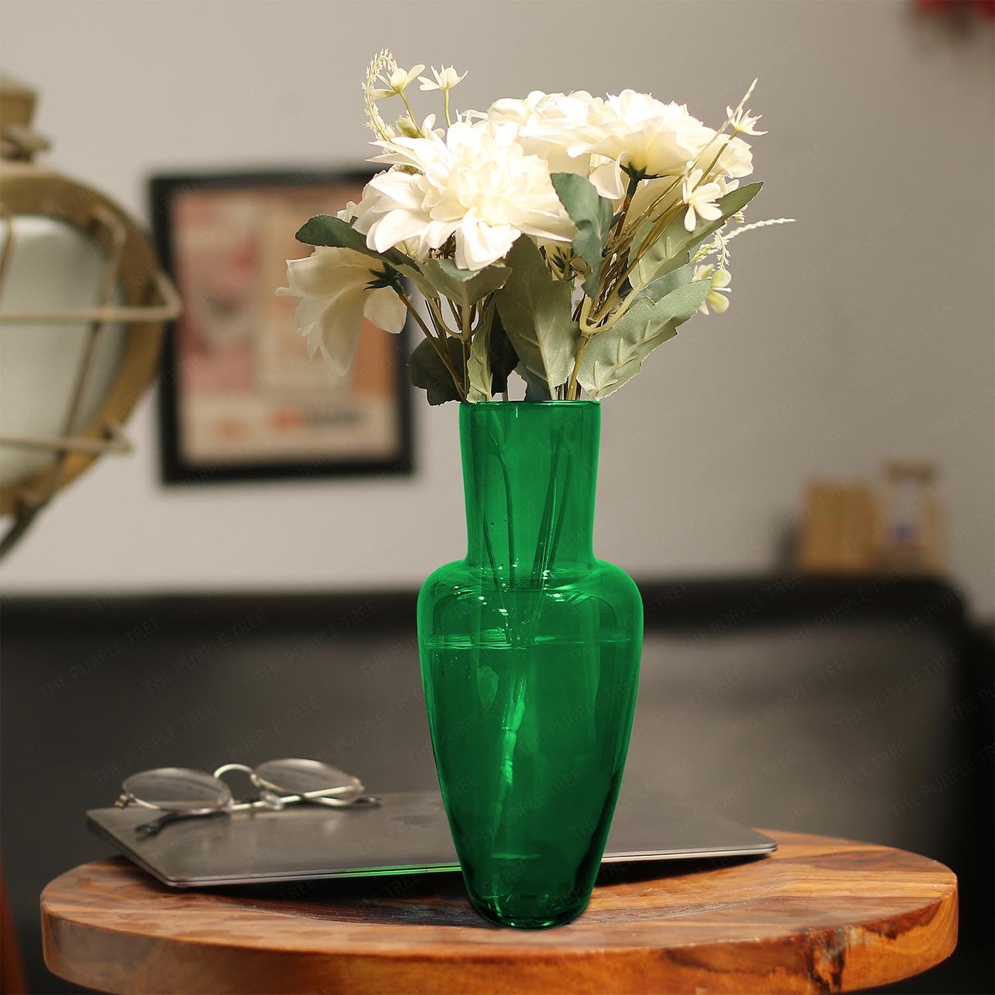 A vase filled with colorful flowers elegantly placed on a wooden table, enhancing the room's decor.
